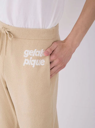 Close-up of Gelato Pique Mens Air Moco logo jacquard lounge pants with elastic waistband and side pocket in soft beige fabric.