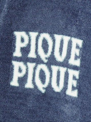 Close-up of Gelato Pique Smoothie fabric texture with ‘Pique Pique’ text, showcasing luxurious and soft cardigan material.