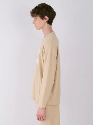 Side profile of a person wearing a Gelato Pique MENS Air Moco Logo Sweatshirt in beige, showcasing its soft fabric and minimalist design.