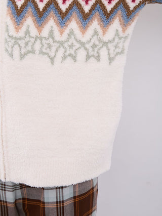 Close-up of Fair Isle-inspired powder shawl collar cardigan with plaid pants, showcasing intricate soft knit pattern.