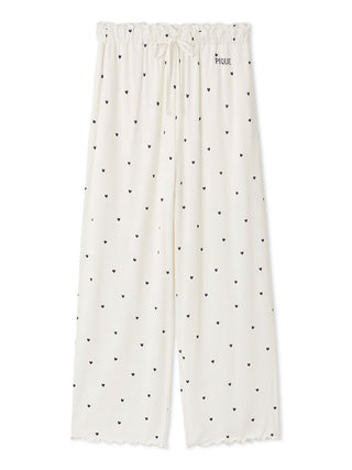 Gelato Pique women’s white wide-leg pajama pants with black heart print, elastic ruffle waistband, and embroidered logo.