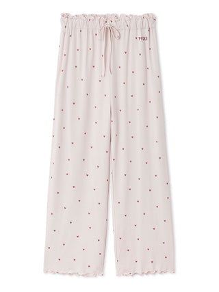 Gelato Pique women’s pink wide-leg pajama pants with black heart print, elastic ruffle waistband, and embroidered logo.