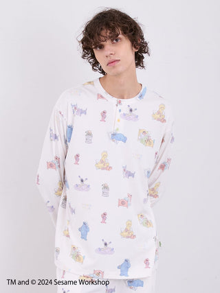 Man wearing Sesame Street men's all-over print Henley-neck pullover in colorful gelato pique design.