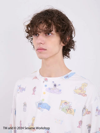 Model wearing Sesame Street men's henley-neck pullover with colorful all-over print by gelato pique, inspired by Sesame Street, front view.