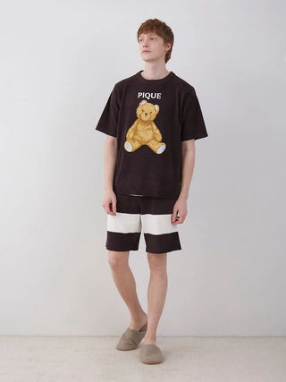 Model wearing Gelato Pique Men's Air Moco 2 Border Lounge Shorts in striped pattern, paired with a teddy bear graphic t-shirt.