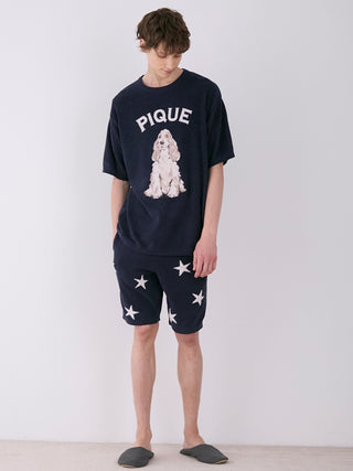 Model wearing MEN'S Air Mocostar Jacquard Lounge Shorts with star pattern, paired with a Pique graphic T-shirt in a relaxed setting.