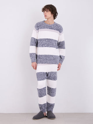 Person wearing mens powder melange striped fuzzy pajama pants and matching top, standing against a white background.