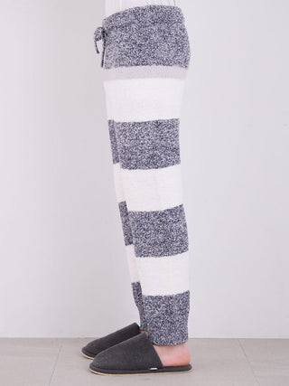 Side view of men's powder melange striped fuzzy pajama pants in grey and white, showcasing cozy and stylish design.