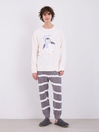 Model wearing men's Baby Moco Aran striped cable knit pajama pants with a cozy sweater, showcasing classic and comfortable loungewear.