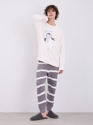 Model wearing Mens Baby Moco Aran Striped Cable Knit Pajama Pants in gray and white, showcasing cozy and stylish sleepwear fashion.