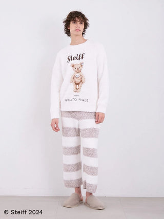 Model wearing Steiff Men's Gelato 2 Border Fuzzy Pajama Pants with bold striped pattern and cozy knit fabric.