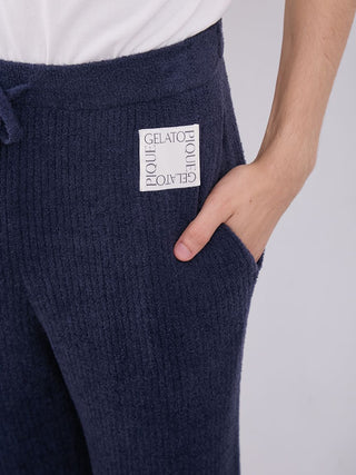 Close-up of MEN's Hot Smoothie Rib Long Pants in navy blue, showcasing the rib-knit texture and Gelato Pique logo on waistband.