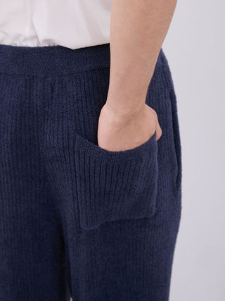 Close-up of a model wearing Men's Hot Smoothie Rib Long Pants in navy blue, showcasing the ribbed texture and pocket detail.