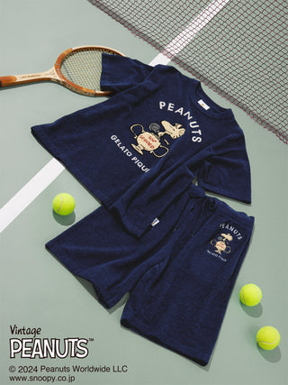 Navy PEANUTS pullover top and shorts featuring Snoopy as a tennis player, set on a tennis court with rackets and balls.