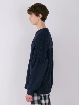 Side view of a model wearing a navy MEN'S Air Moco Aran Pullover Sweater featuring classic Aran knit details by Gelato Pique.