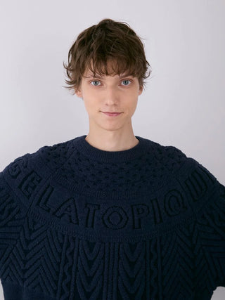 Model wearing the Men's Air Moco Aran Pullover Sweater in navy with Aran knit detailing by Gelato Pique.