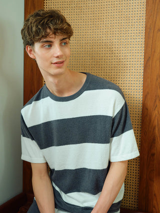 Alt Tag: Model wearing MEN'S Smoothie Lite Striped Knit Top in gray and white, showcasing soft 'Smoothie' fabric by Gelato Pique.