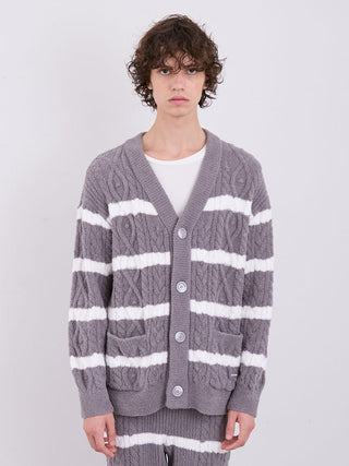 Model wearing Men's Baby Moco Aran Border Button-Up Cardigan with gray and white stripe cable knit pattern by Gelato Pique.