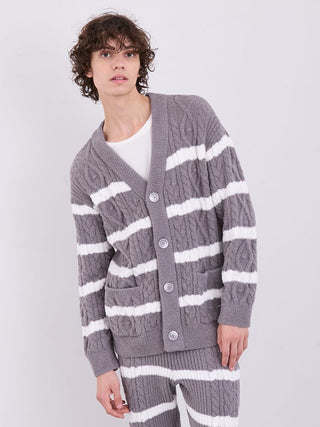 Model wearing Men's Baby Moco Aran Border Button-Up Cardigan with cable knit and stripe pattern for cozy style.