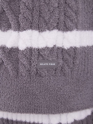 Close-up of Baby Moco Aran Border Sweater fabric in gray with white stripes, featuring Gelato Pique label.