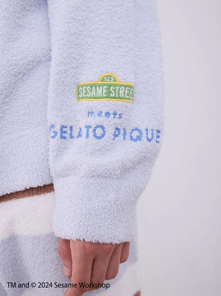 Close-up of Sesame Street men's loungewear sleeve with logos, featuring soft Baby Moco fabric for comfort and style.