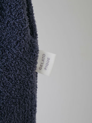 Close-up of Gelato Pique USA navy fabric label, showcasing premium material.