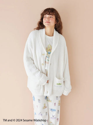 Person wearing Sesame Street unisex powder motif jacquard shawl cardigan, featuring a cozy, elegant design for warmth and comfort.