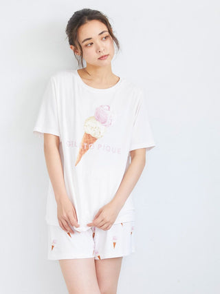 Woman wearing ice cream print lounge shorts with matching top, featuring playful ice cream cone design for relaxed loungewear style.