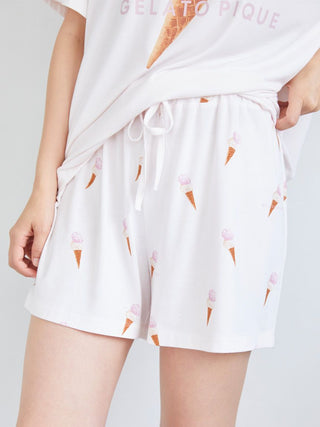 Woman wearing ice cream print lounge shorts with elastic waistband, showcasing playful and whimsical summer style.