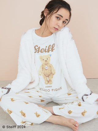 Woman wearing Steiff pajama pants with teddy bear print, showcasing comfortable lounge fashion.