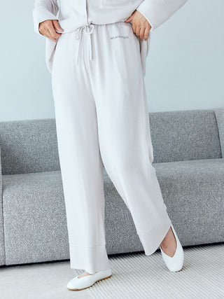 Woman wearing Gelato Pique Snow Lounge Pants in heather gray, showcasing comfort and style perfect for home or casual outings.