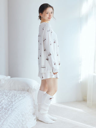 Woman wearing Gelato Pique USA white panda pattern lounge shorts, showcasing premium loungewear and sleepwear style in a sunlit bedroom.