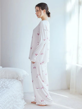 Woman wearing white pajama pants with brown and pink panda pattern from Gelato Pique USA, premium loungewear and sleepwear.