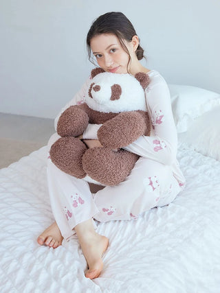 Woman wearing Gelato Pique USA panda pattern pajama pants in brown and pink, highlighting premium loungewear and sleepwear.