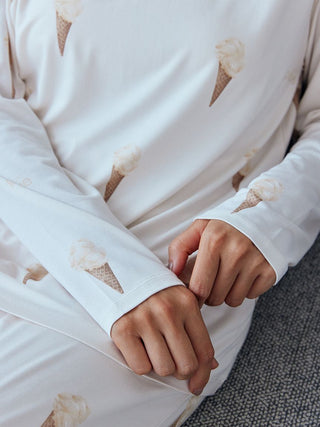 Close-up of a long sleeve pajama shirt with an ice cream cone print on a light cream background, showcasing soft fabric and whimsical design.