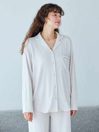 Woman wearing Snow Long Sleeve Pajama Shirt in white, showcasing soft and elegant nightwear perfect for comfort and relaxation.