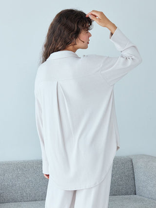 Woman wearing Snow Long Sleeve Pajama Shirt in snow-white, showcasing its elegance and comfort, perfect for nighttime or lounging.