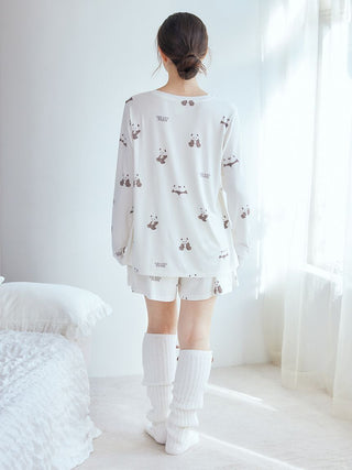 Model wearing Gelato Pique USA white panda pattern long sleeve T-shirt and shorts, premium loungewear, showcasing adorable design.