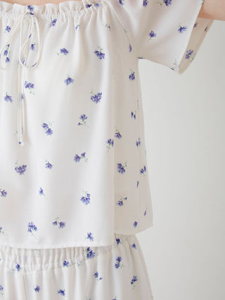 Floral Print Smocked Crop Top in white with blue flowers, featuring an elastic neckline, perfect for a fresh and feminine look.