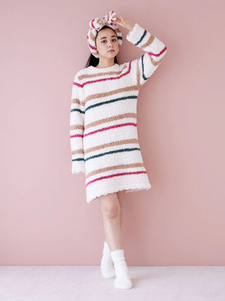 Model wearing Gelato Plush Lounge Headband with oversized bow and festive stripes, paired with a cozy striped sweater, against pink background.