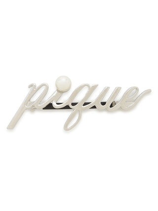 Sleek metal barrette with "Pique" script logo and pearl accent, showcasing a minimalist design for stylish hair accessory.