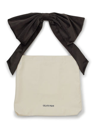 Ribbon Tote Bag by Gelato Pique with oversized black bow and beige body, offering elegance and functionality. Perfect for everyday use.