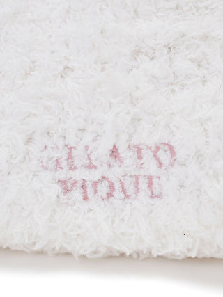 Close-up of Gelato Pique logo on a fluffy white fabric texture, symbolizing premium loungewear and sleepwear quality in gentle hues.