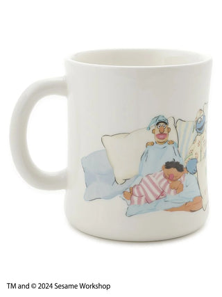 SESAME STREET ceramic mug with bedtime scenes of characters like Elmo and Big Bird, perfect for enjoying hot drinks.