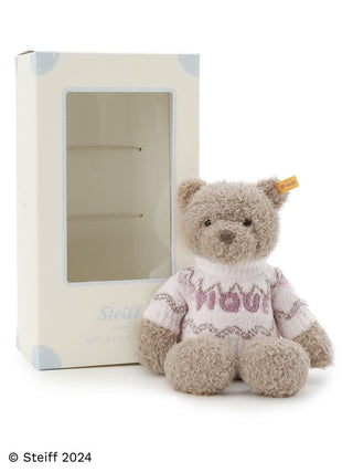 Steiff Teddy Bear Jimmy by Gelato Pique in a cozy sweater, showcasing soft plush texture with packaging box on display.