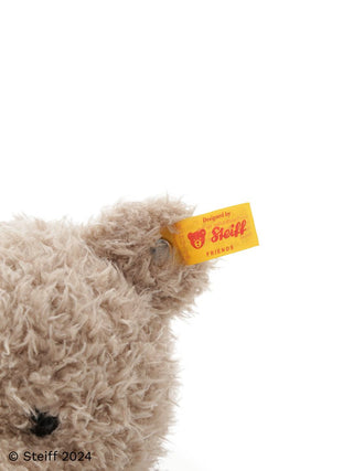 Close-up of Steiff Teddy Bear Jimmy's ear with Steiff tag, highlighting the soft, fluffy texture from the Steiff and Gelato Pique collaboration.