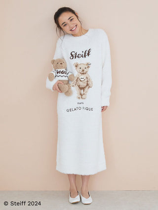 Woman wearing Steiff x Gelato Pique dress holding Teddy Bear Jimmy, showcasing cozy and stylish collaboration design.