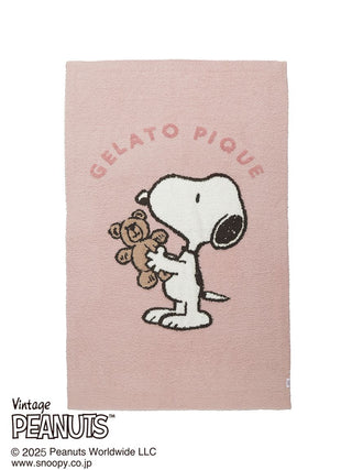 Snoopy holding a teddy bear on a pink Gelato Pique jacquard throw blanket, featuring a vintage Peanuts design.