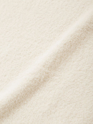 Close-up of soft cream fabric texture, featuring a plush and cozy finish. Ideal for premium loungewear and sleepwear by Gelato Pique USA.