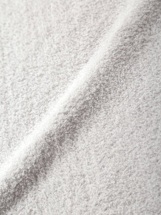 Close-up of soft, textured grey fabric perfect for cozying up with a CAT Jacquard Throw Blanket.